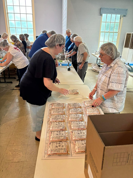 Volunteers completing process at Rise Against Hunger Event