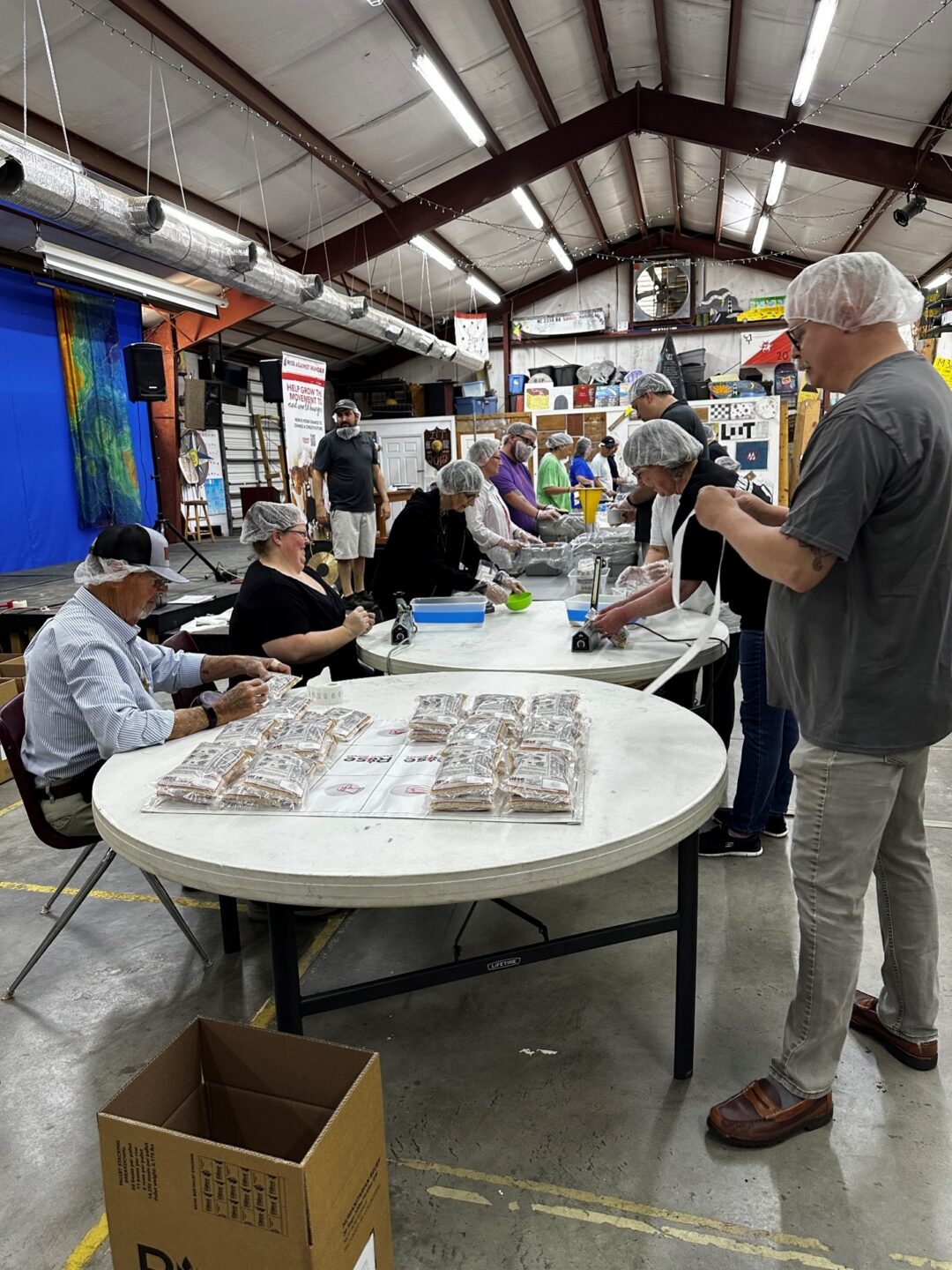 Volunteers filling the meal bags at Rise Against Hunger Event - Sound District